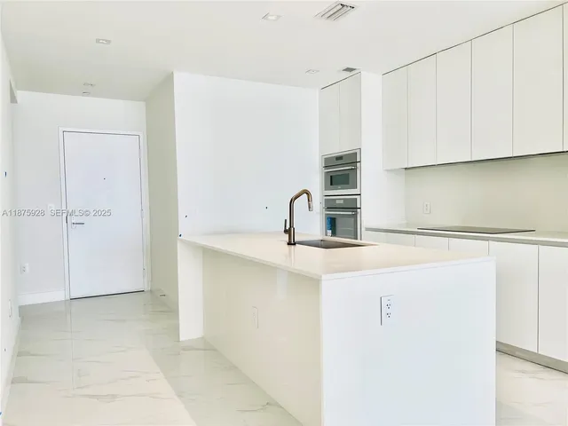 a bathroom with a tub shower and sink