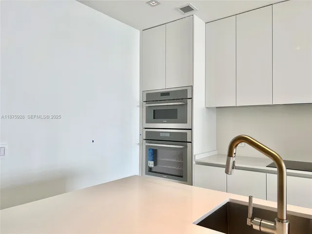 a view of a room with wooden floor and window