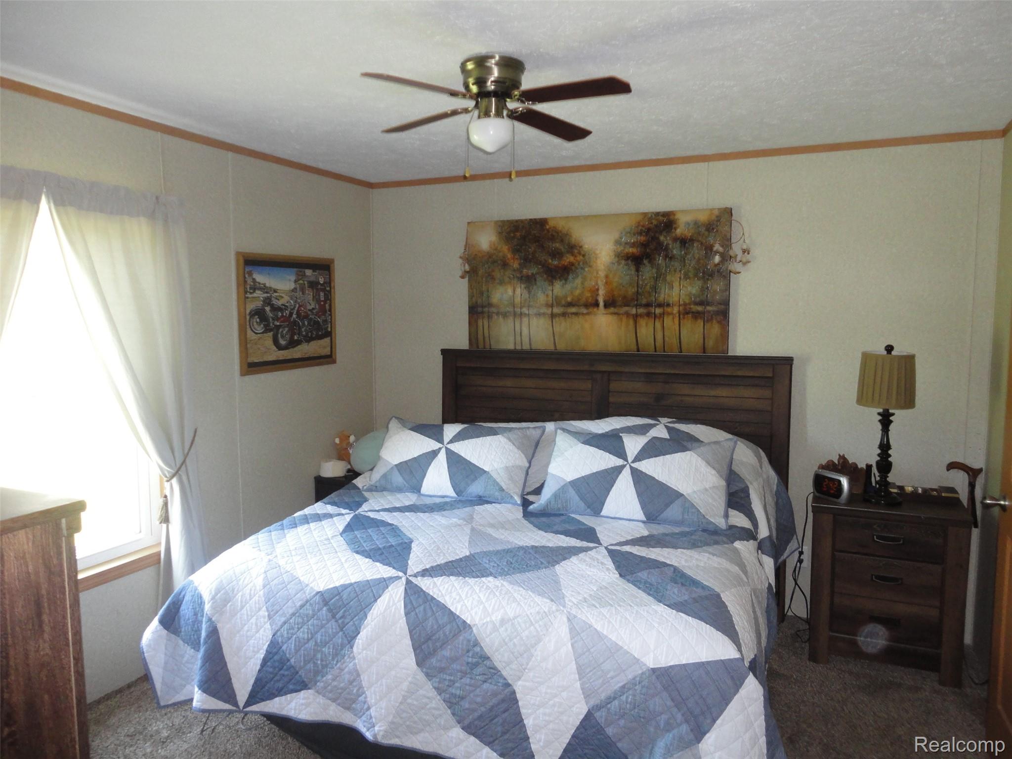 463 Edinborough Temperance, MI 48182 - Photo 7 of 23 Bedroom, Interior space featuring a wood-finish headboard, light-toned walls, and a ceiling fan with integrated lighting
