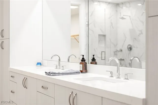 a bathroom with a double vanity sink and a mirror