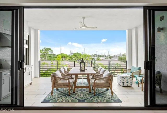 a dining room with furniture and a floor to ceiling window