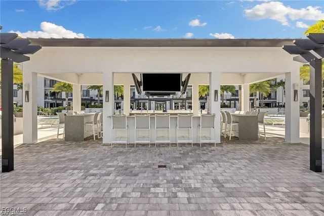 a view of a patio with couches and table with swimming pool and outdoor seating