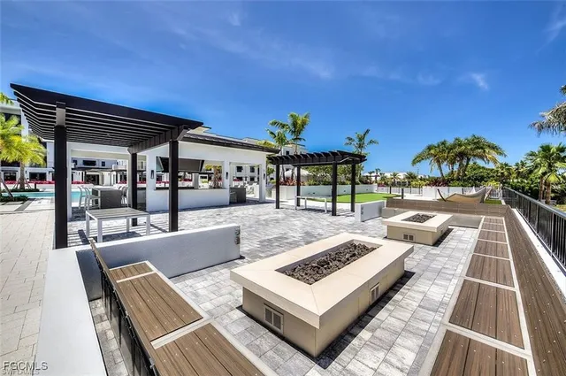a view of swimming pool with outdoor seating and a patio