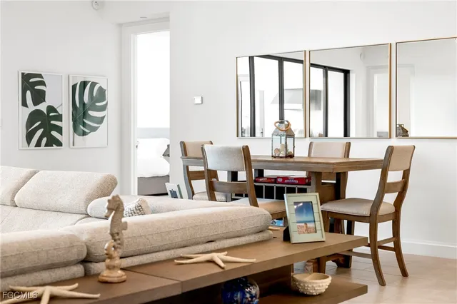 a living room with furniture and large windows