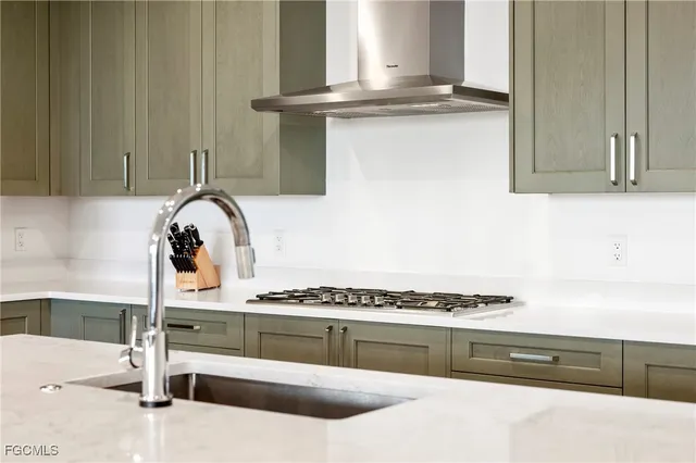 a kitchen with granite countertop a stove and a sink