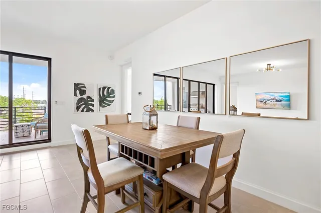 a view of a dining room with furniture and a potted plant