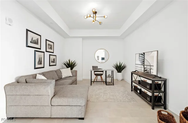 a living room with furniture a table and a potted plant