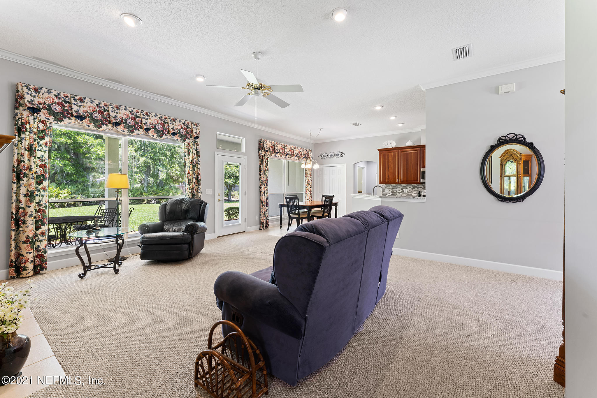 2284 Emilys Way Fleming Island, FL 32003 - Photo 11 of 52 a living room with furniture a large window and a chandelier