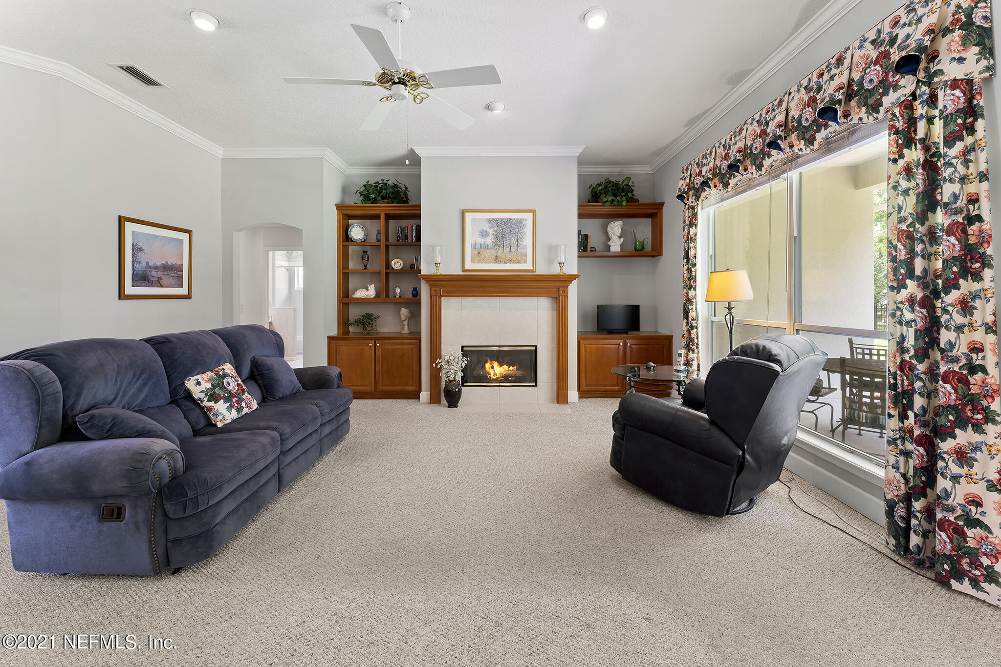 2284 Emilys Way Fleming Island, FL 32003 - Photo 12 of 52 a living room with furniture a fireplace and a large window