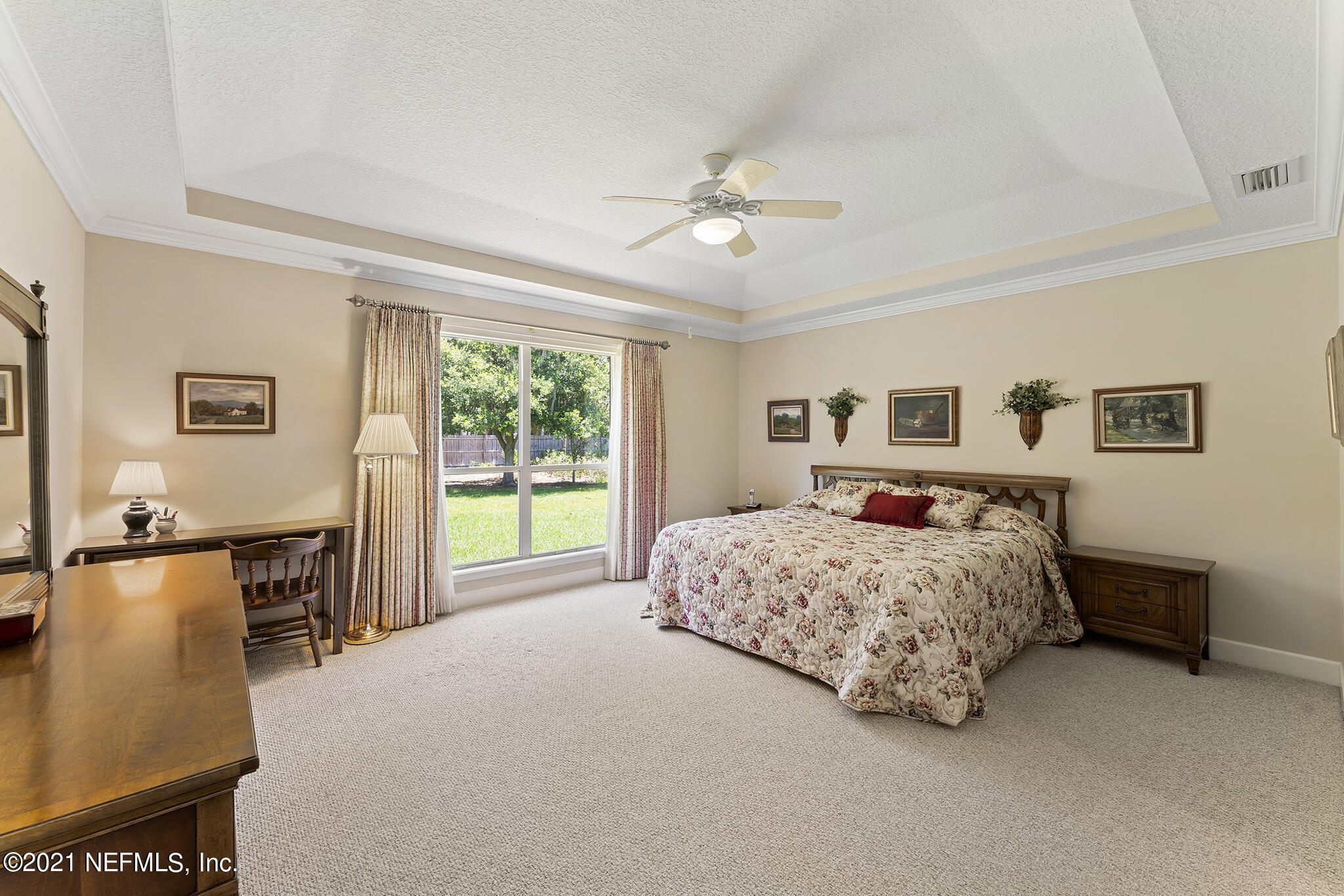 2284 Emilys Way Fleming Island, FL 32003 - Photo 15 of 52 a living room with a bed furniture and a large window