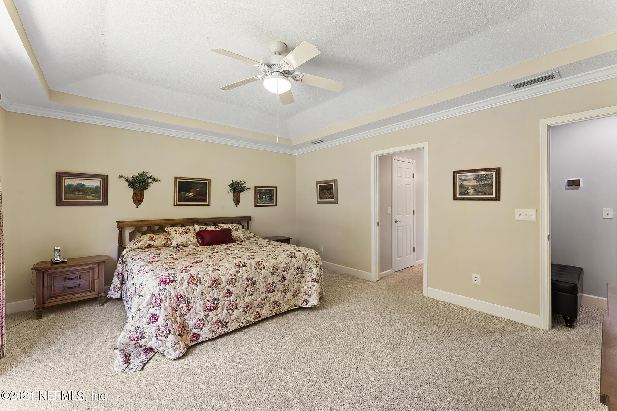 2284 Emilys Way Fleming Island, FL 32003 - Photo 16 of 52 a bedroom with a large bed and a chandelier