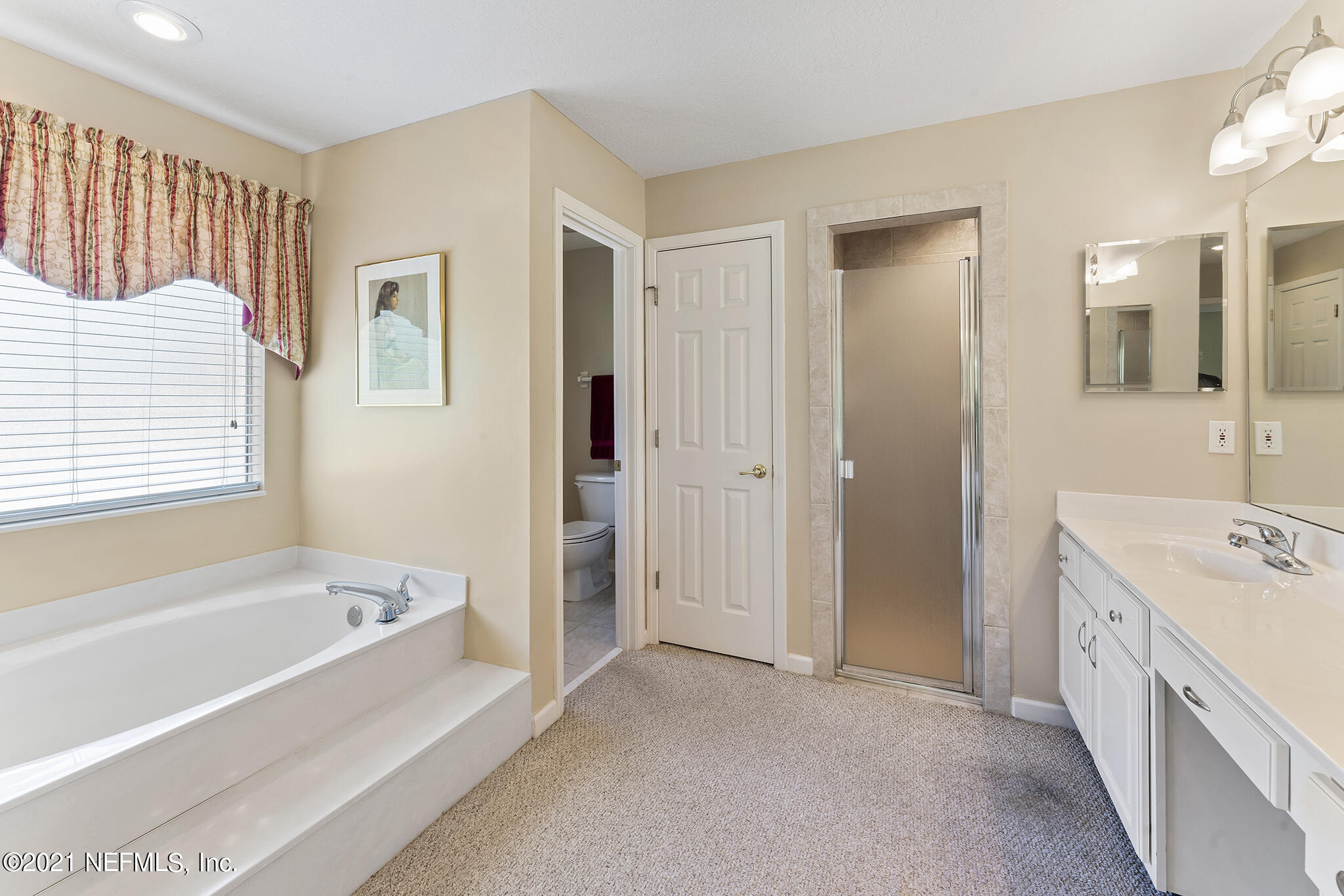 2284 Emilys Way Fleming Island, FL 32003 - Photo 19 of 52 a spacious bathroom with a tub sink and mirror