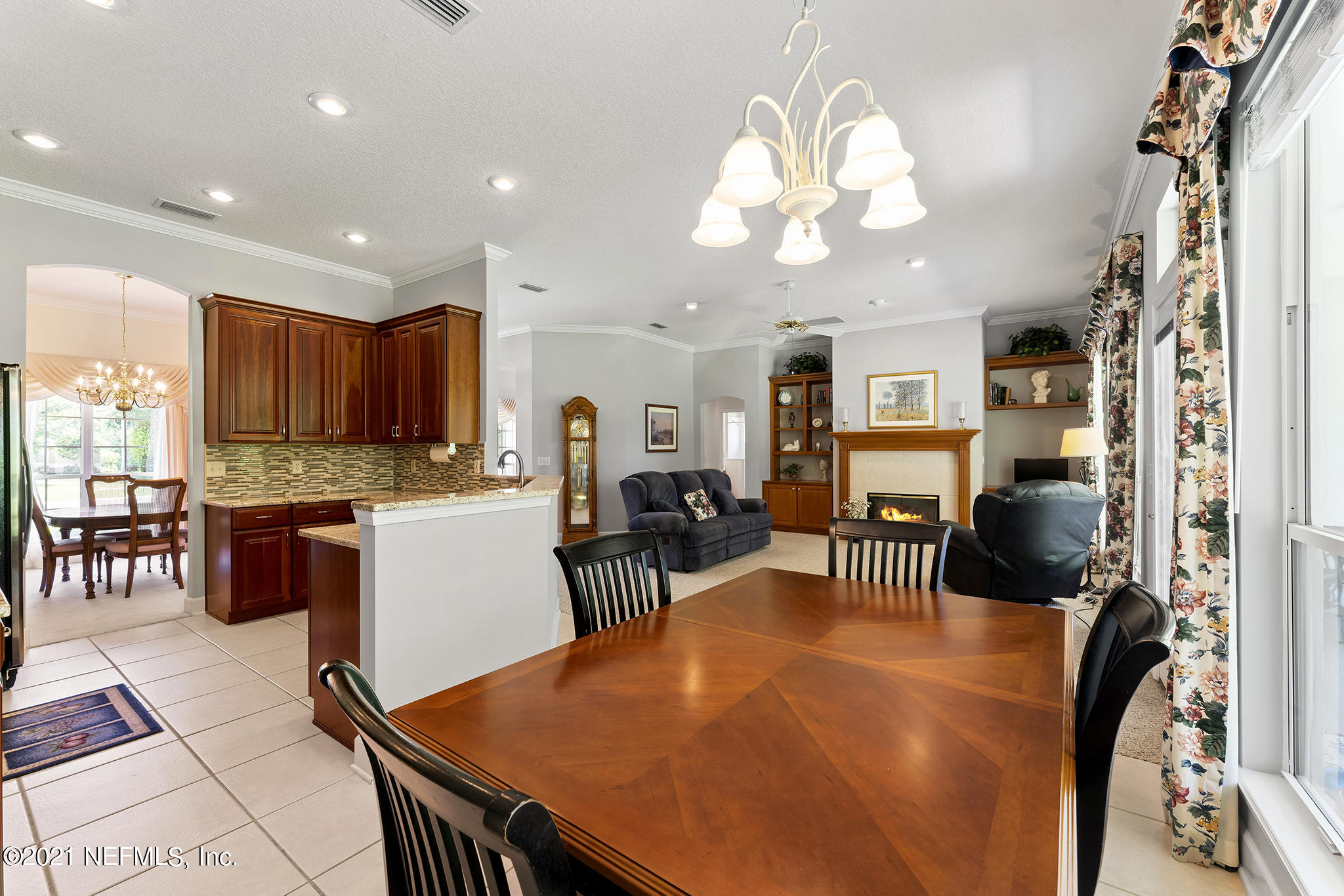 2284 Emilys Way Fleming Island, FL 32003 - Photo 25 of 52 a view of a dining room with furniture and a chandelier