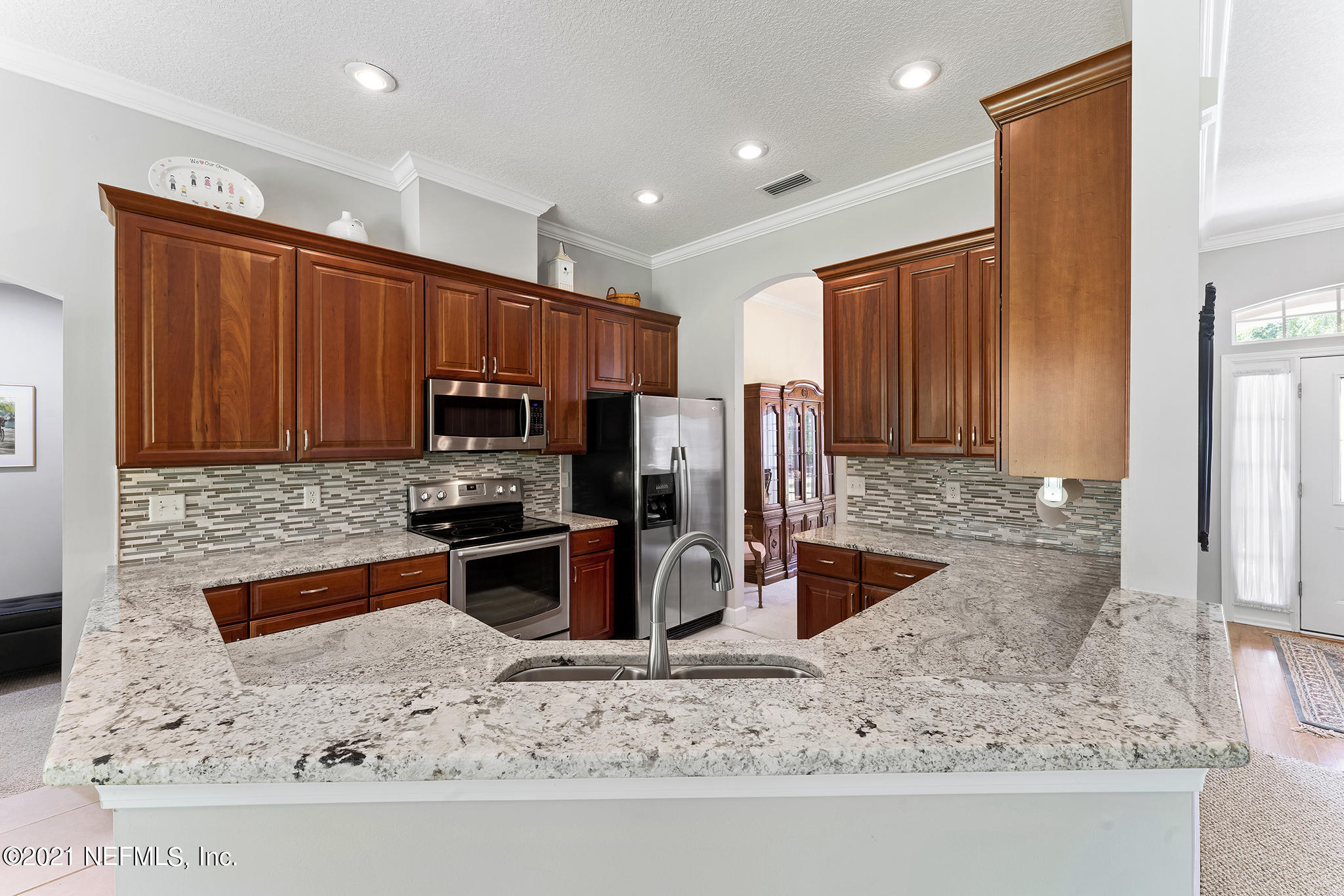 2284 Emilys Way Fleming Island, FL 32003 - Photo 26 of 52 a kitchen with stainless steel appliances granite countertop a sink stove and refrigerator