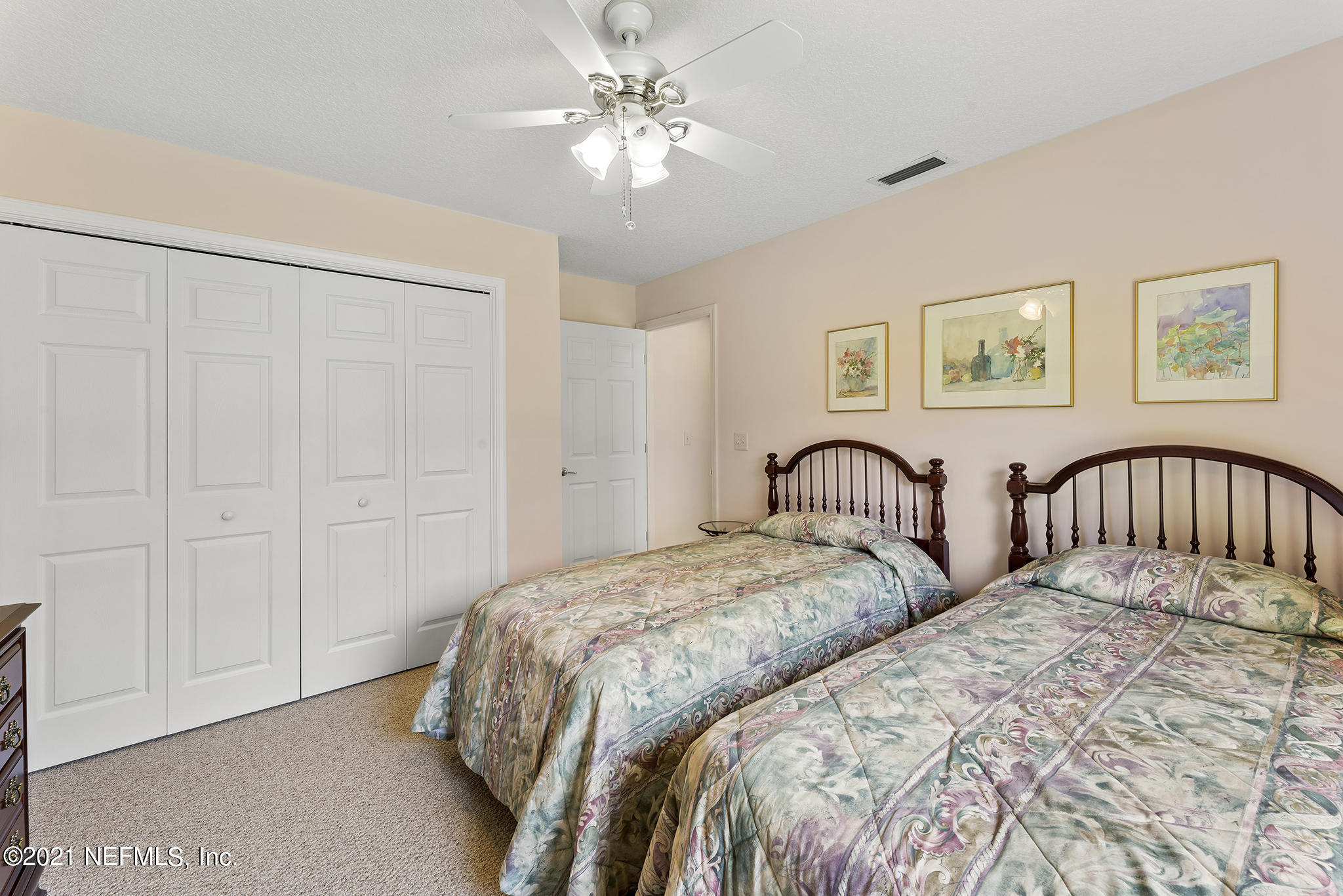 2284 Emilys Way Fleming Island, FL 32003 - Photo 29 of 52 a bedroom with two beds and a chandelier