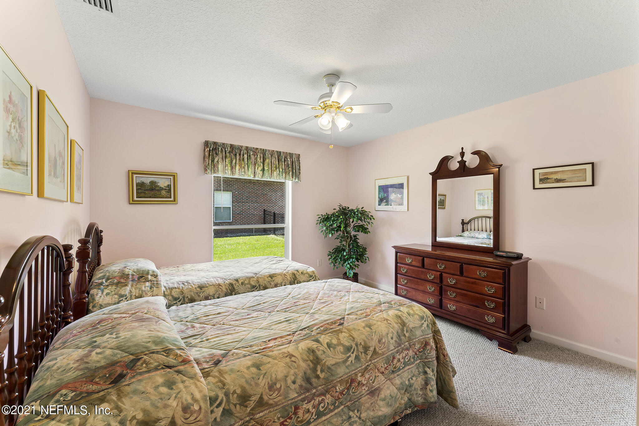 2284 Emilys Way Fleming Island, FL 32003 - Photo 30 of 52 a bedroom with a bed dresser and a window