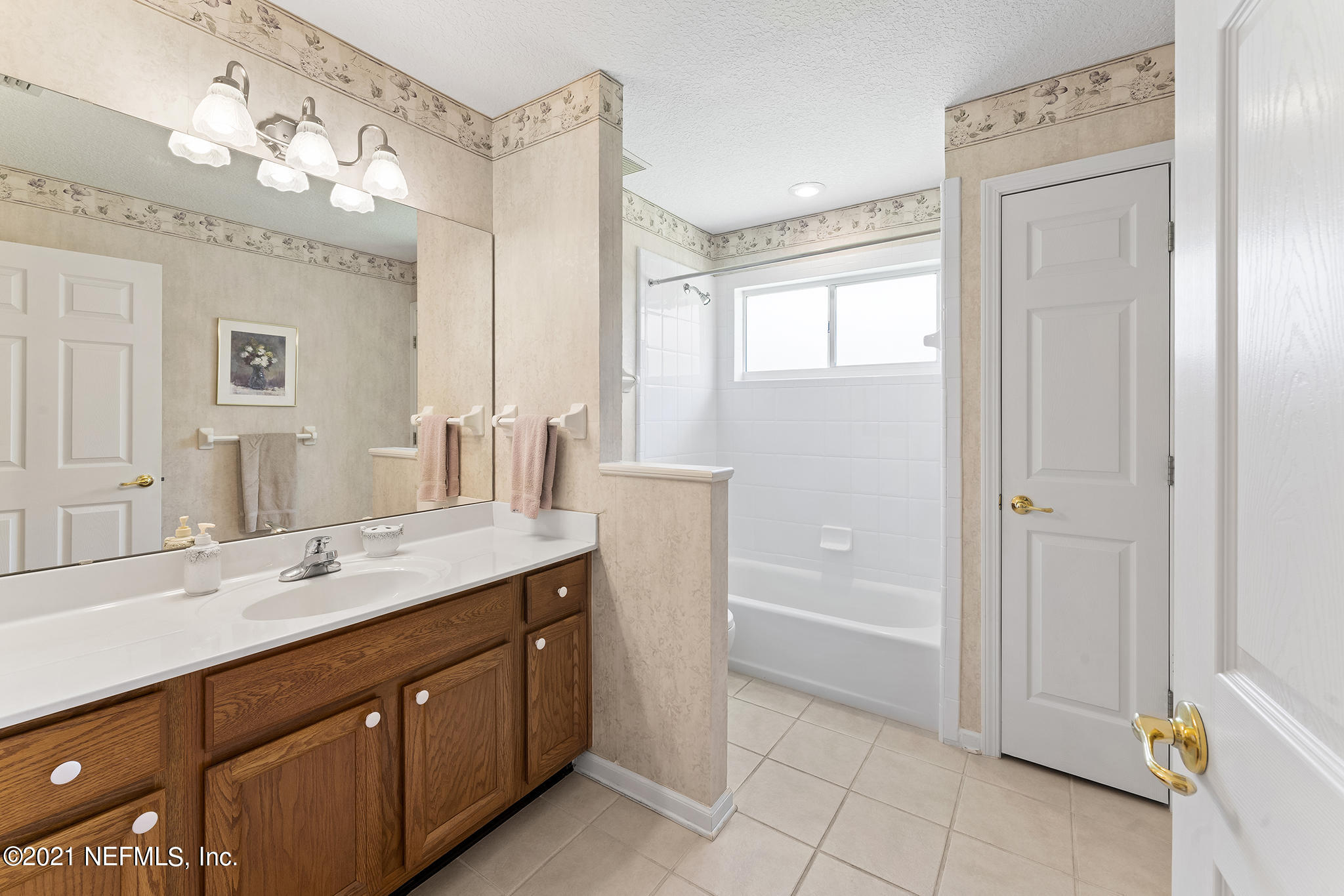 2284 Emilys Way Fleming Island, FL 32003 - Photo 32 of 52 a spacious bathroom with a granite countertop sink a mirror and a bathtub