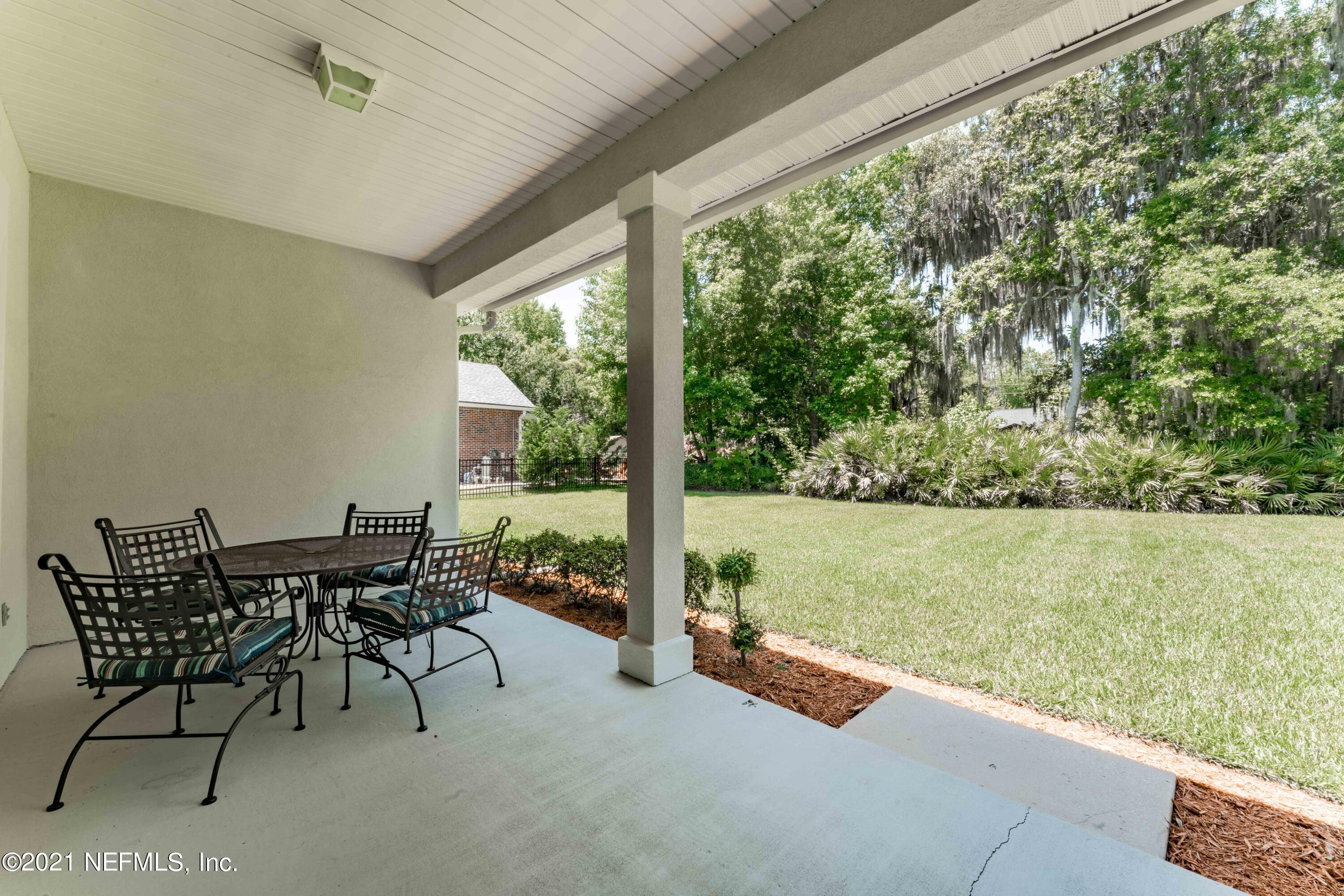 2284 Emilys Way Fleming Island, FL 32003 - Photo 33 of 52 a view of a patio with chairs and table in patio