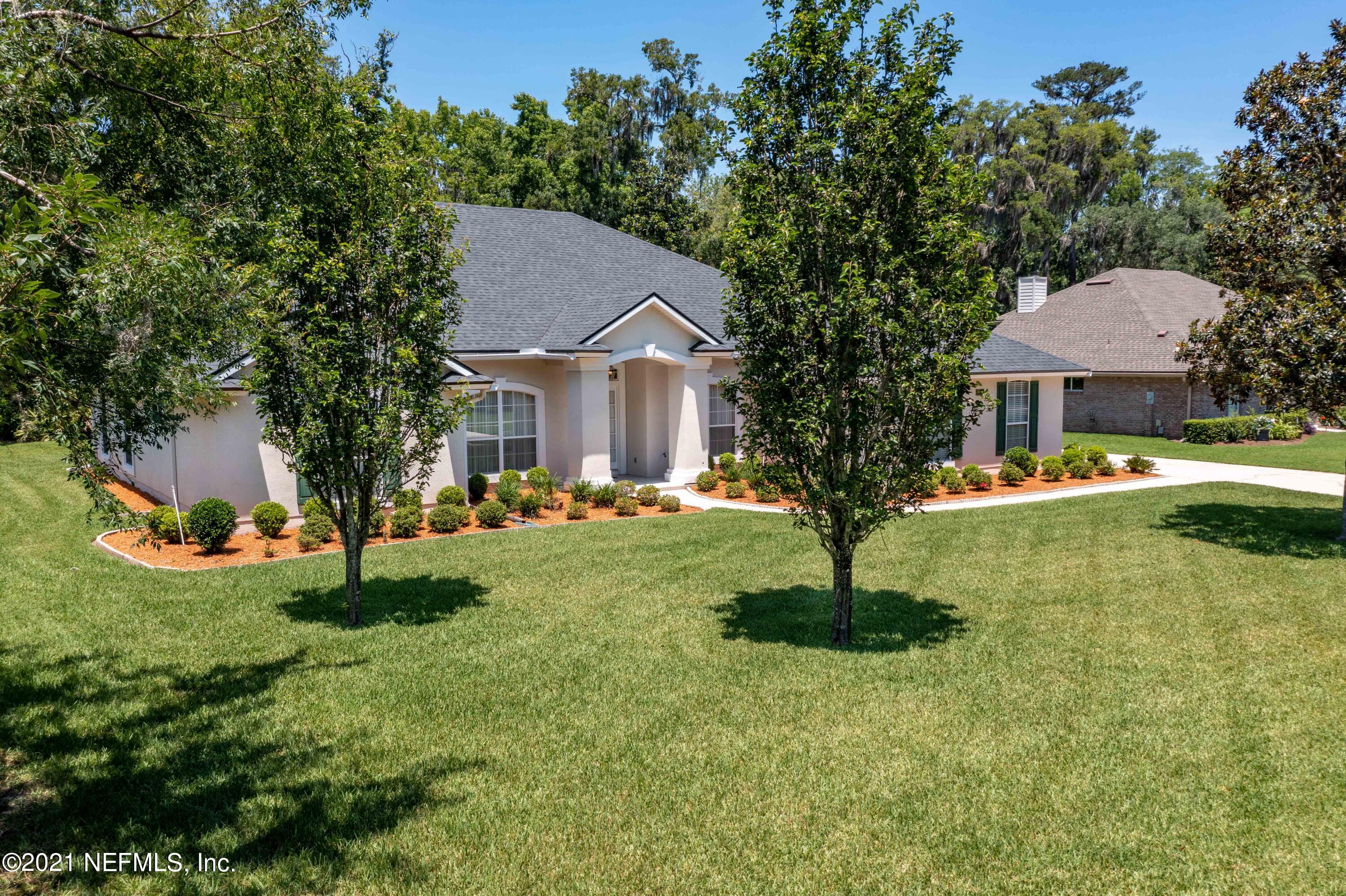 2284 Emilys Way Fleming Island, FL 32003 - Photo 42 of 52 a front view of a house with garden