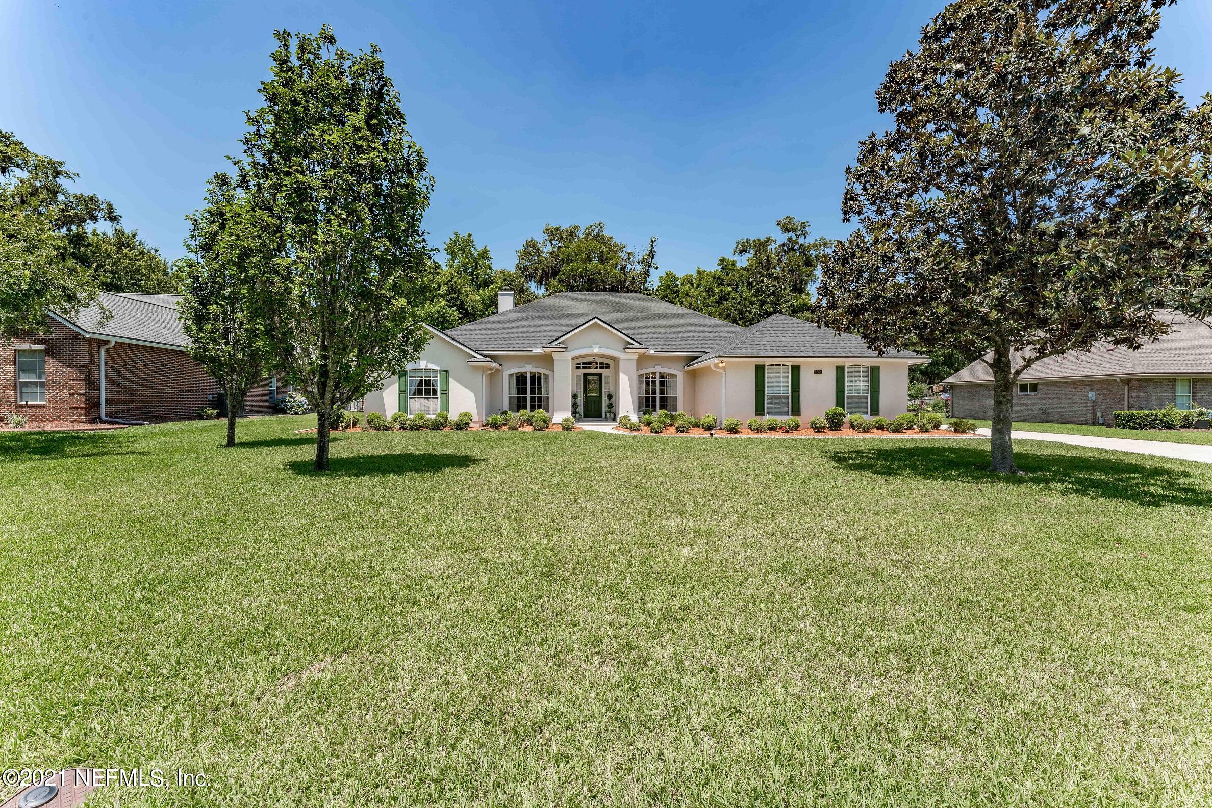 2284 Emilys Way Fleming Island, FL 32003 - Photo 44 of 52 a front view of a house with garden