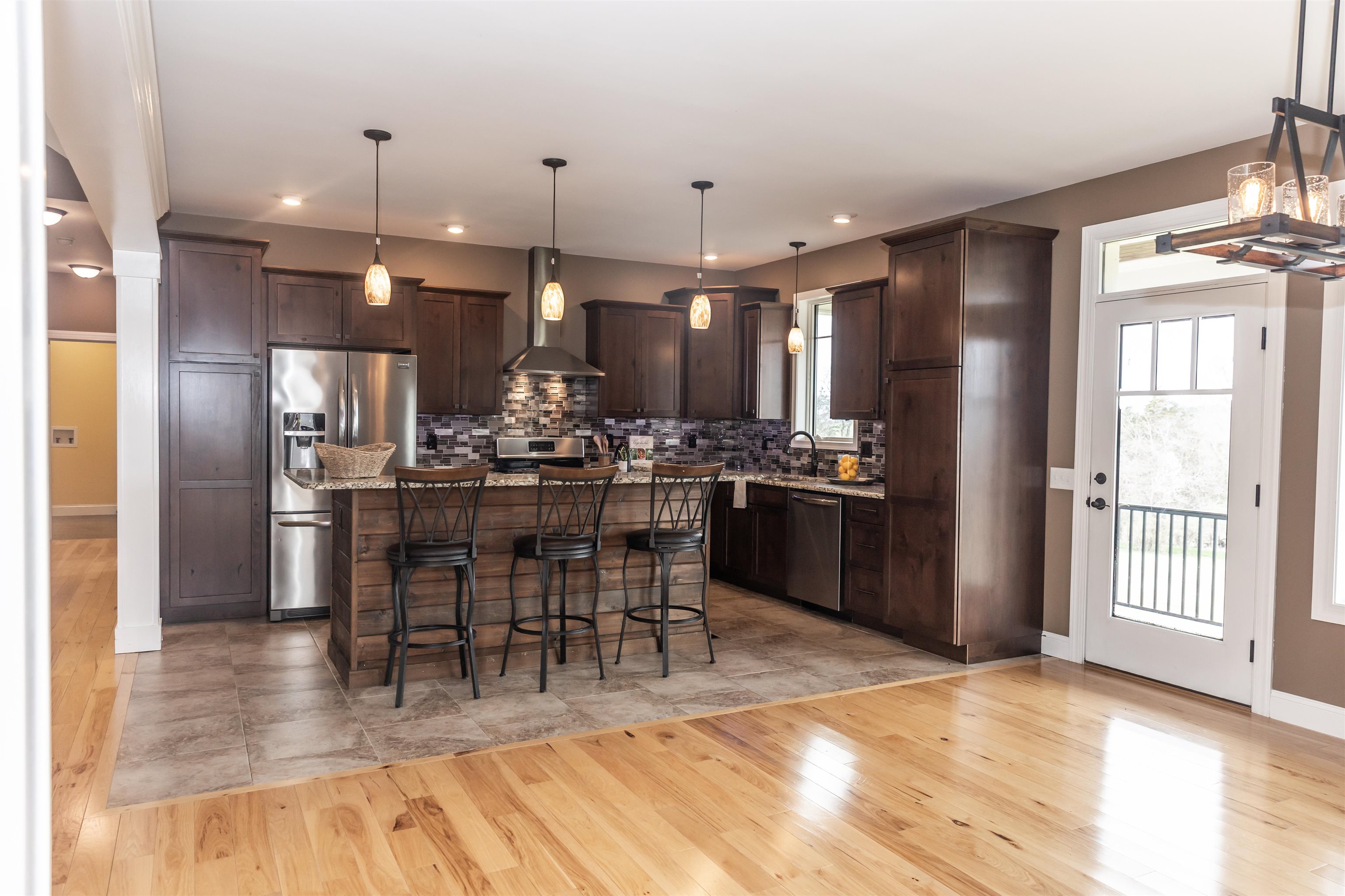 165 Marl Ridge Road Lexington, VA 24450 - Photo 22 of 72 a kitchen with stainless steel appliances kitchen island granite countertop a refrigerator a stove a sink a dining table and chairs with wooden floor