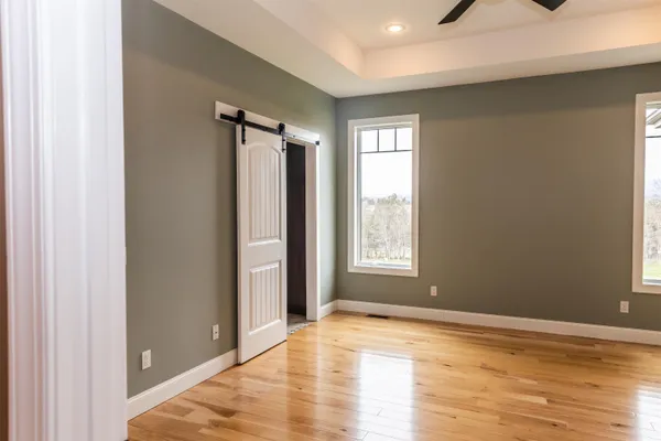 a view of a livingroom with a window and a ceiling fan