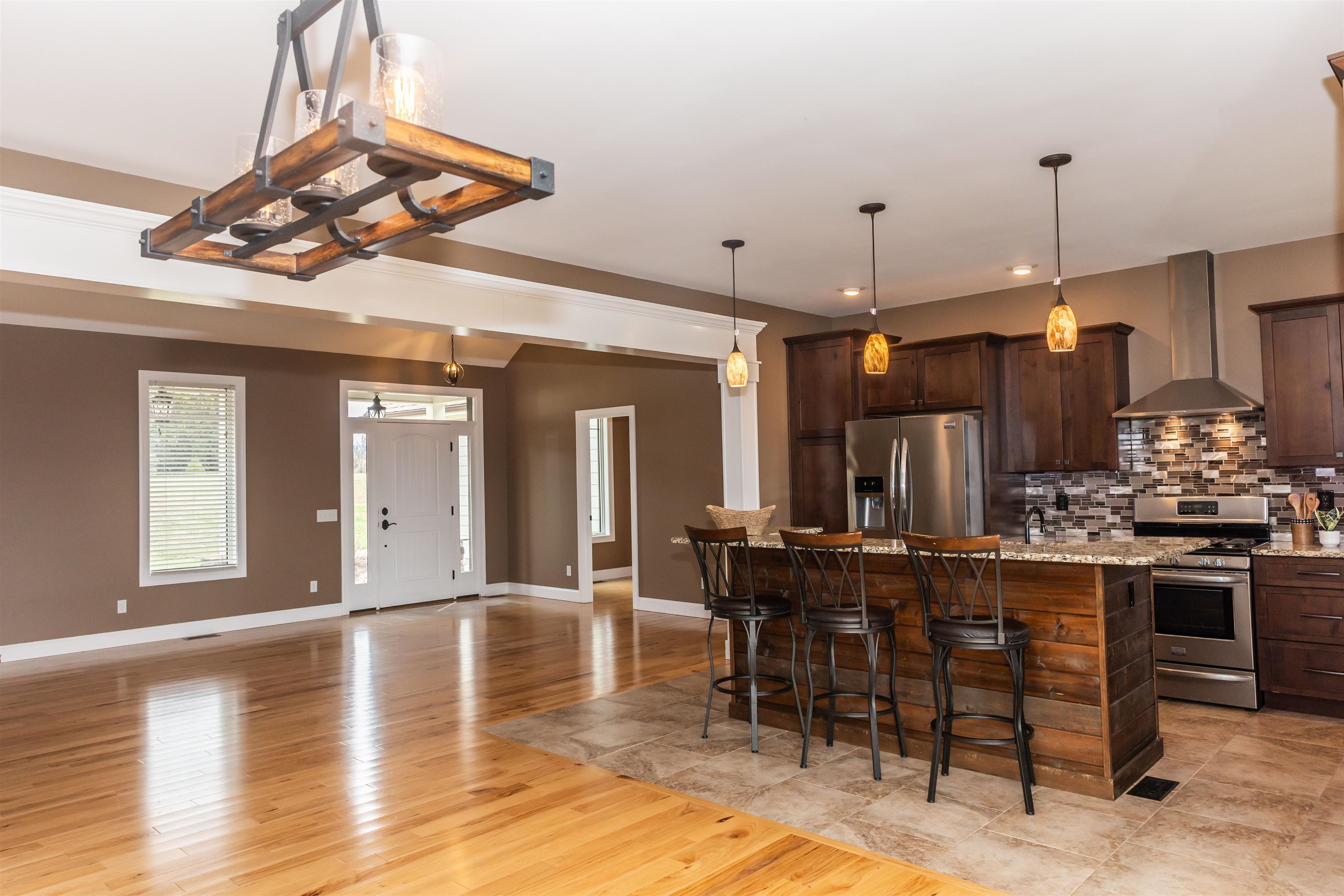 165 Marl Ridge Road Lexington, VA 24450 - Photo 8 of 72 a kitchen with stainless steel appliances granite countertop a stove top oven a dining table and chairs with wooden floor