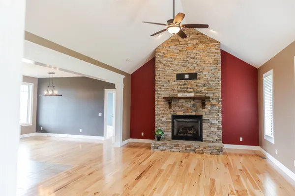 a kitchen with granite countertop a stove a refrigerator and a sink