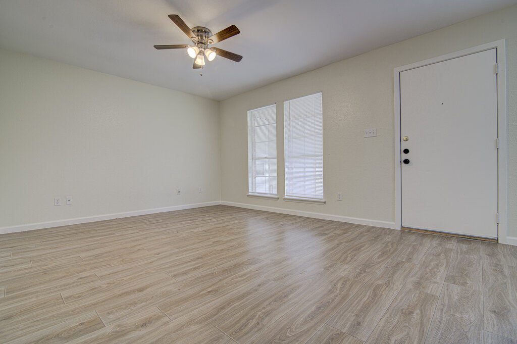 5301 Indio Circle, Unit A Austin, TX 78745 - Photo 4 of 25 A living area with light-toned flooring offers an airy ambiance, complemented by a modern ceiling fan and natural light.