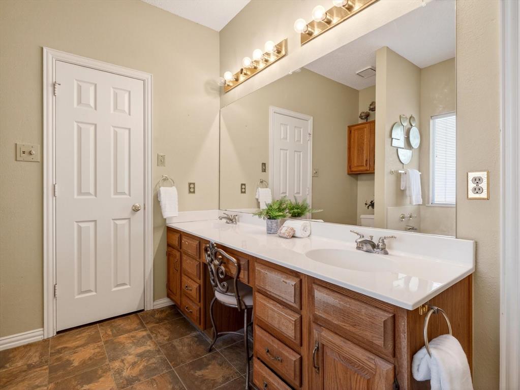 4345 Timberglen Road Dallas, TX 75287 - Photo 16 of 26 a bathroom with a sink and a mirror