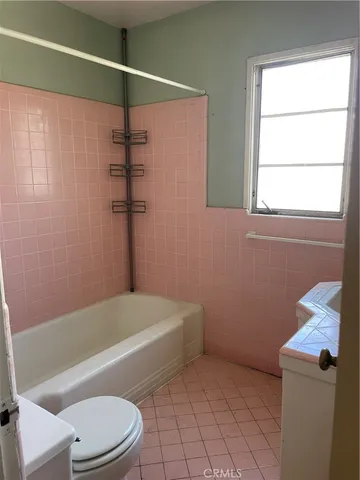 a bathroom with a toilet and a bath tub