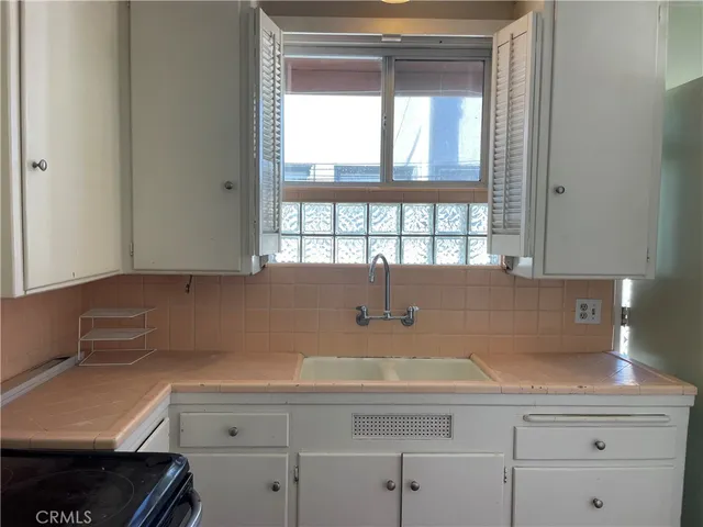 a kitchen with a sink and cabinets