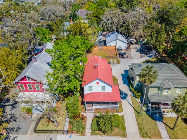 an aerial view of residential houses with outdoor space and street view