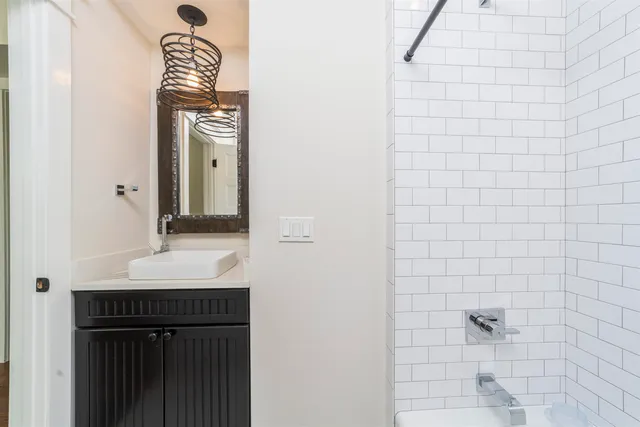 a bathroom with a sink a mirror and a bathtub