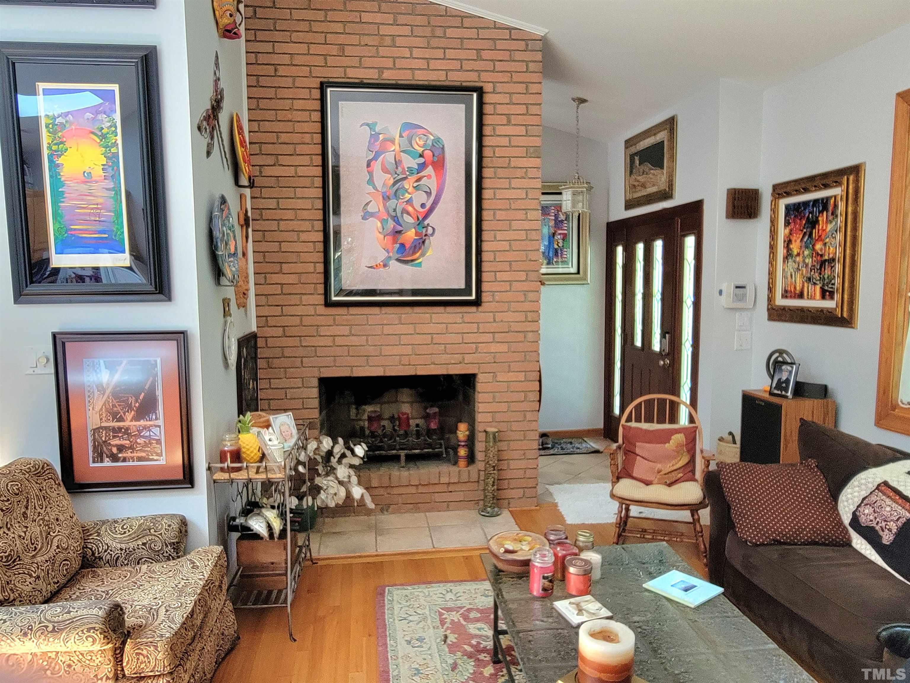 300 Dartmouth Road Raleigh, NC 27609 - Photo 23 of 52 a living room with furniture and a fireplace
