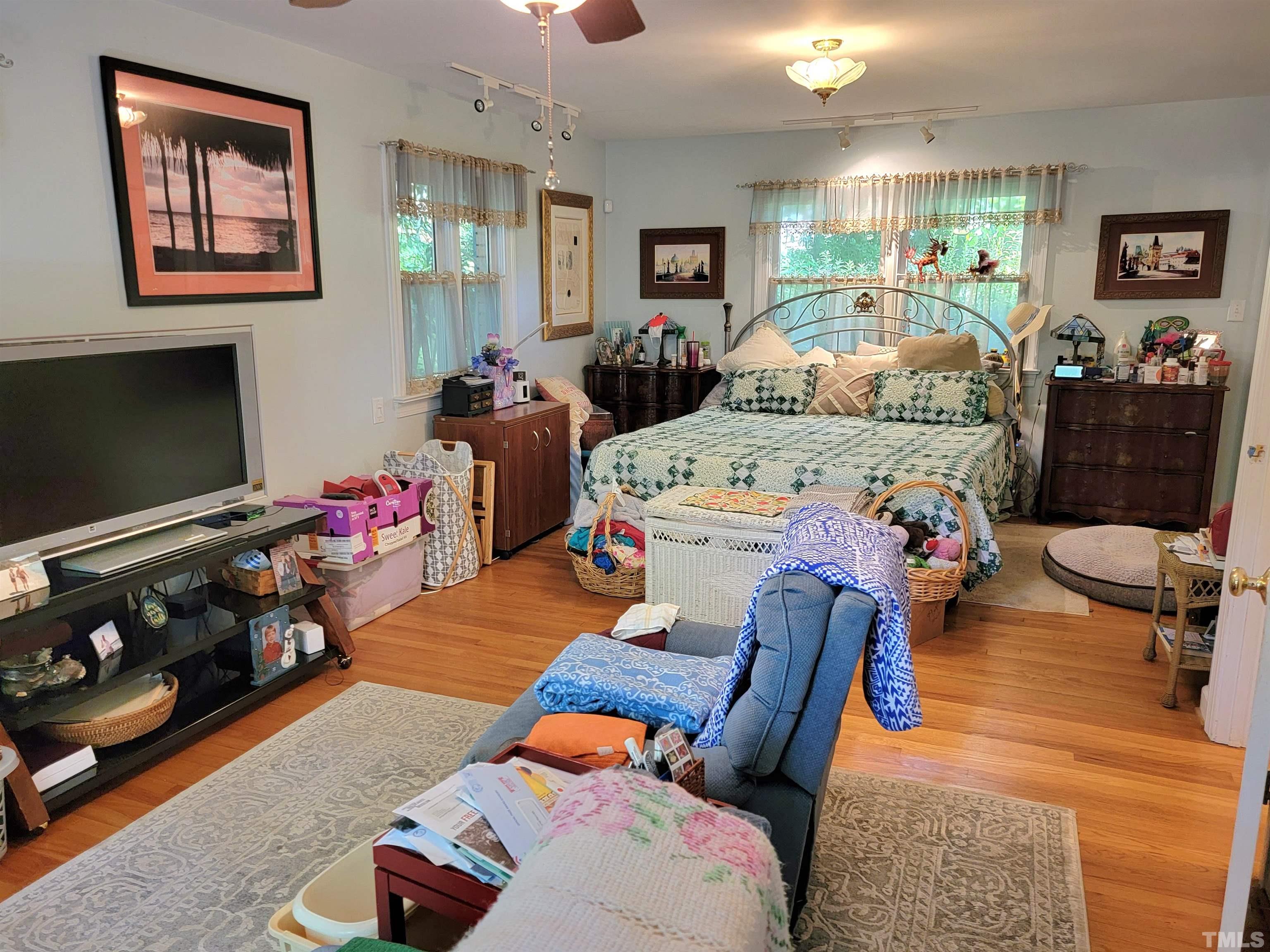 300 Dartmouth Road Raleigh, NC 27609 - Photo 26 of 52 a bedroom with furniture and a flat screen tv