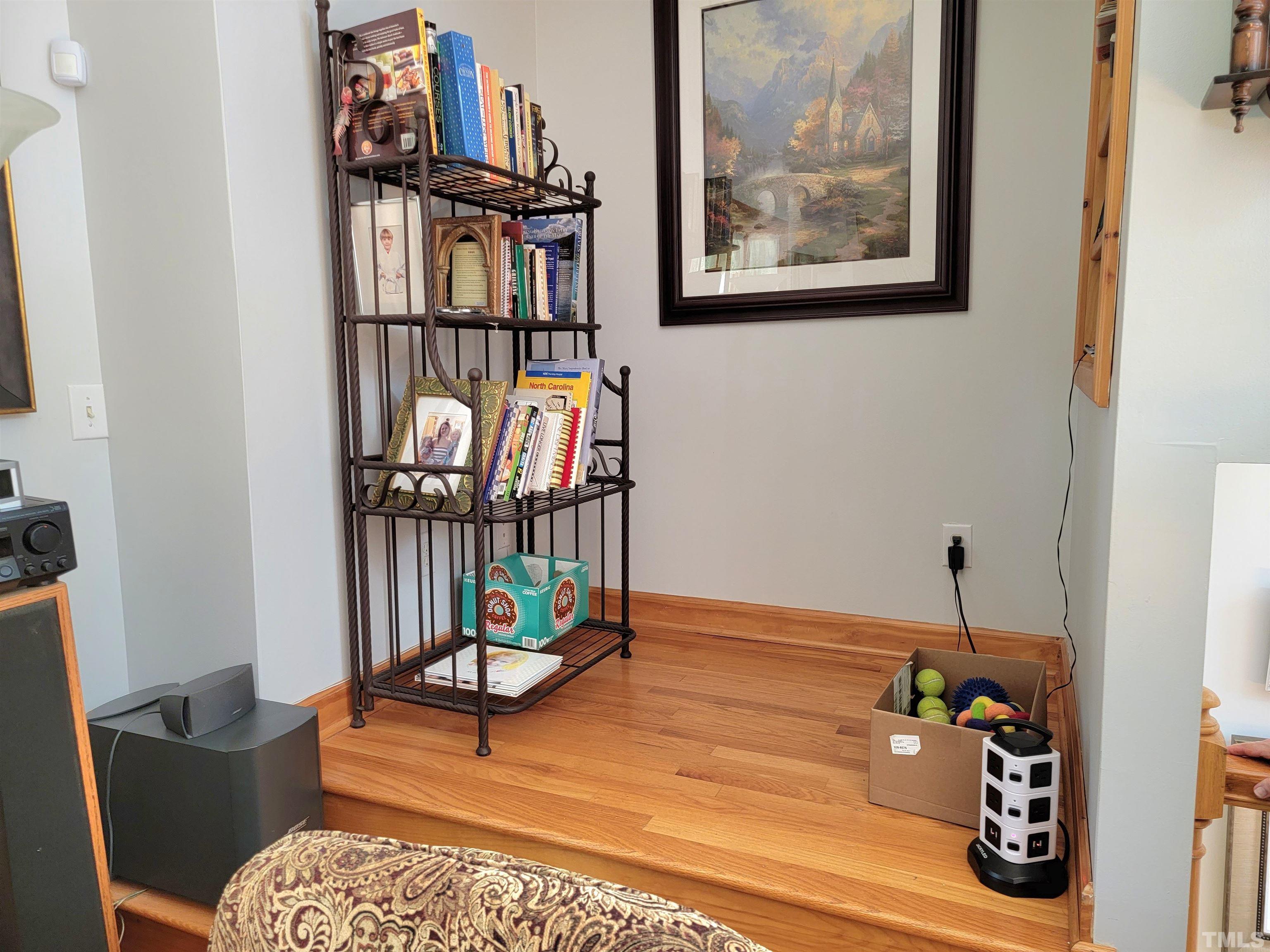 300 Dartmouth Road Raleigh, NC 27609 - Photo 31 of 52 a living room with furniture a rug and a wall painting