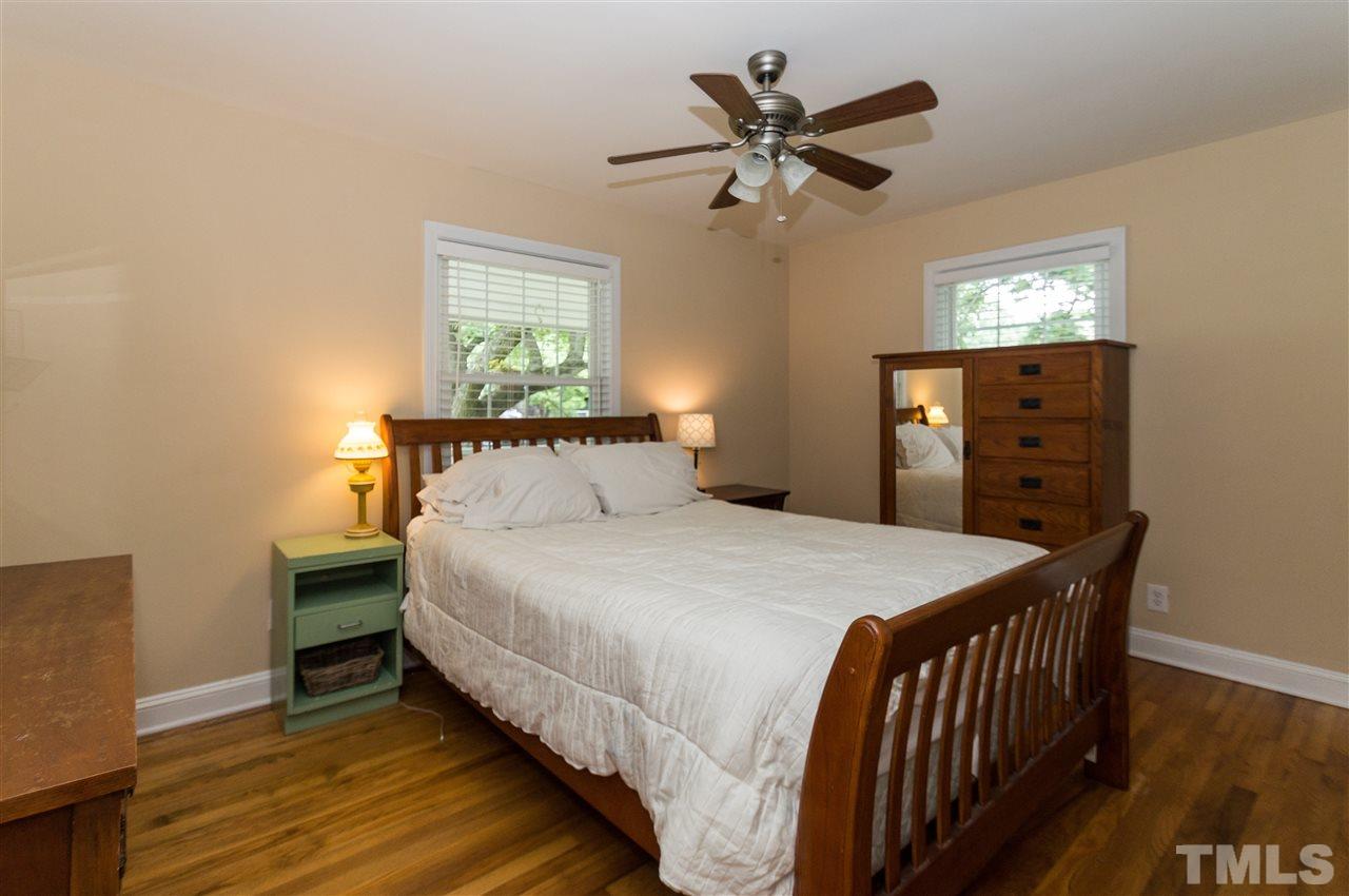 2132 Milburnie Road Raleigh, NC 27610 - Photo 12 of 23 a bedroom with a bed and a chandelier