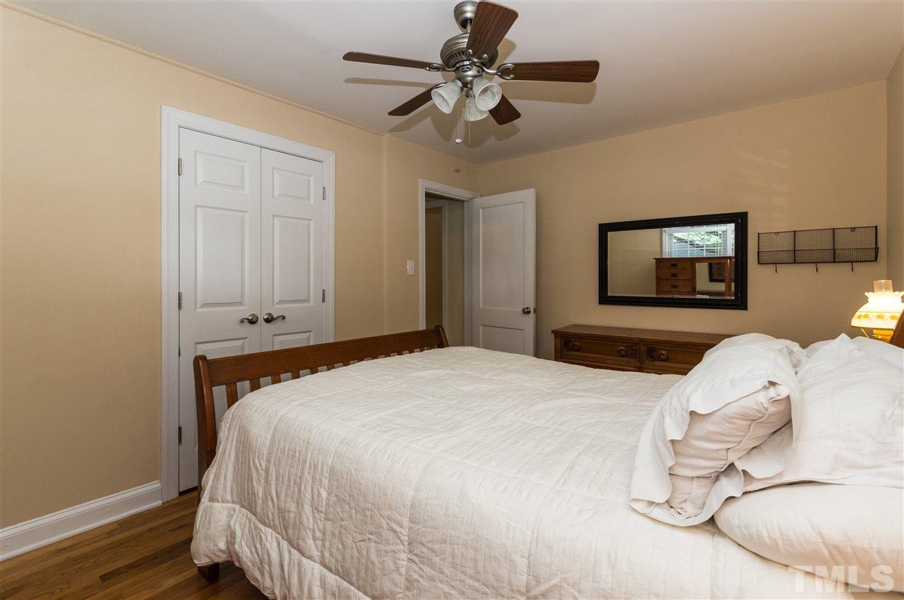 2132 Milburnie Road Raleigh, NC 27610 - Photo 13 of 23 a bedroom with a bed and a chandelier