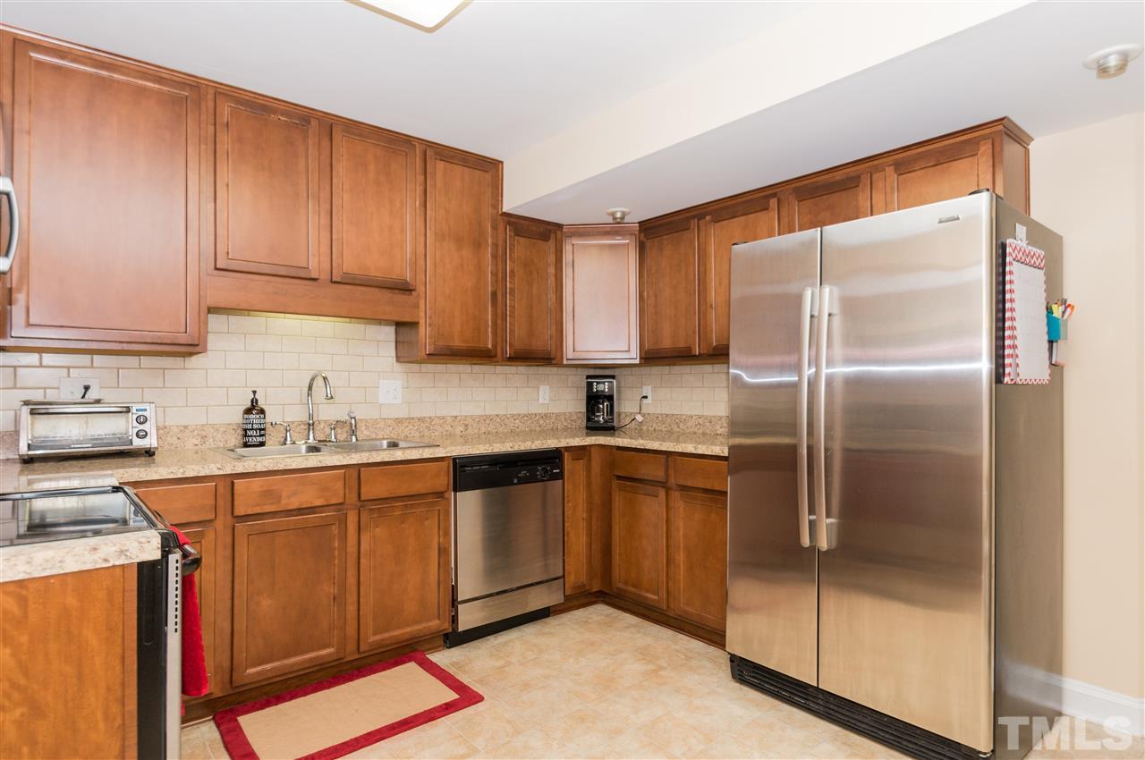 2132 Milburnie Road Raleigh, NC 27610 - Photo 8 of 23 a kitchen with stainless steel appliances granite countertop a refrigerator and a stove top oven