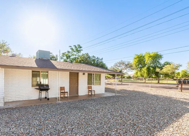 a view of a house with a backyard and a garage