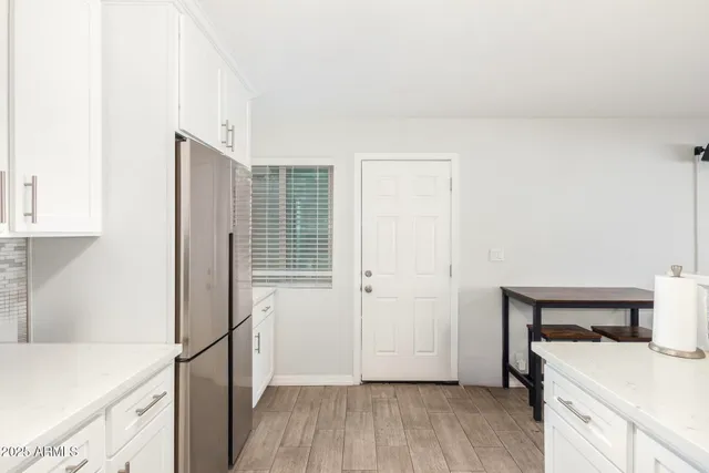 a view of a kitchen with wooden floor and a sink
