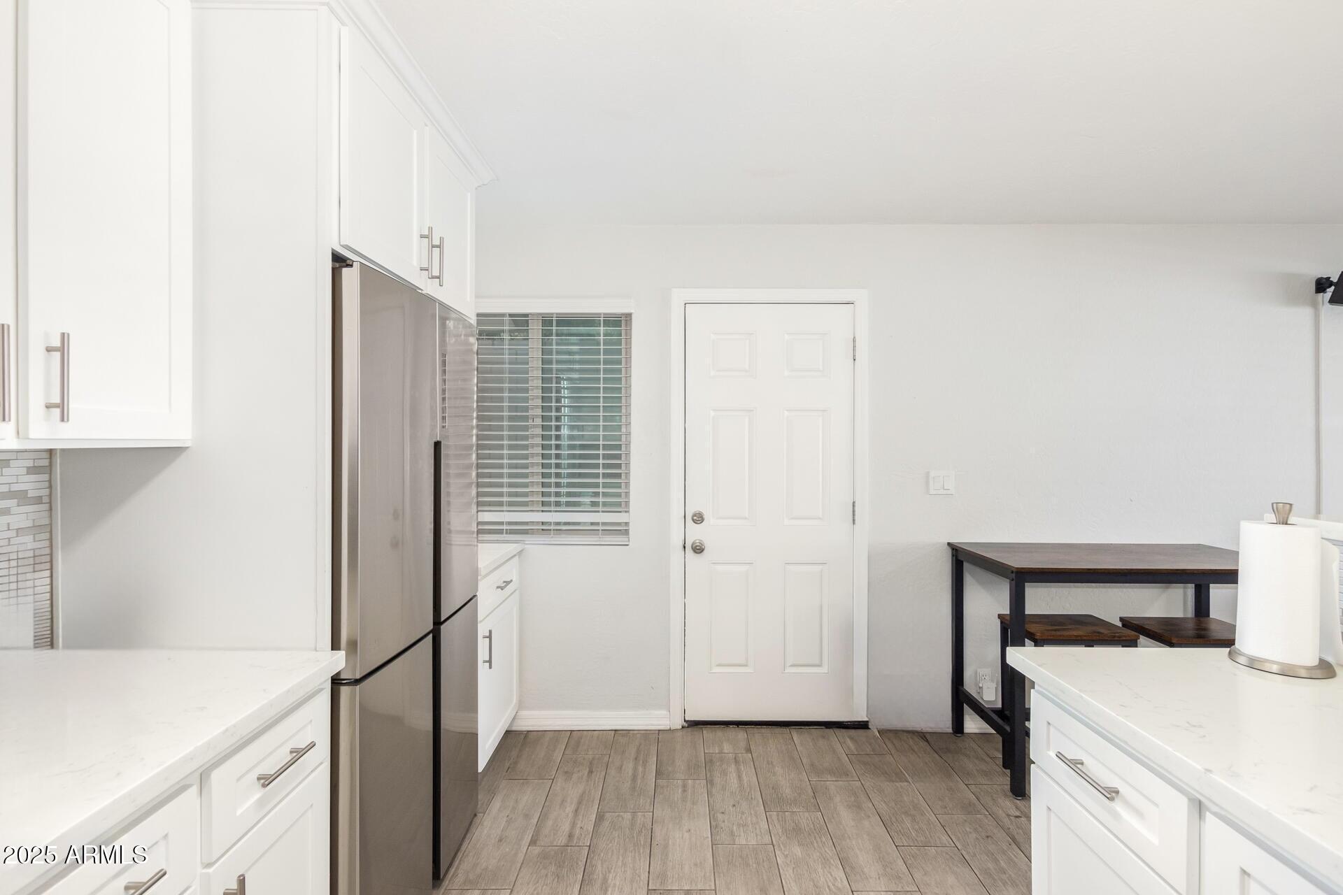 1619 West Peoria Avenue, Unit 2 Phoenix, AZ 85029 - Photo 5 of 8 a view of a kitchen with wooden floor and a sink