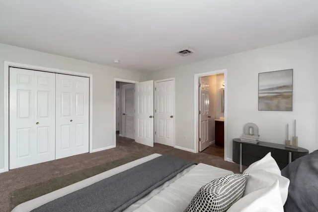 a bedroom with a bed and a lamp