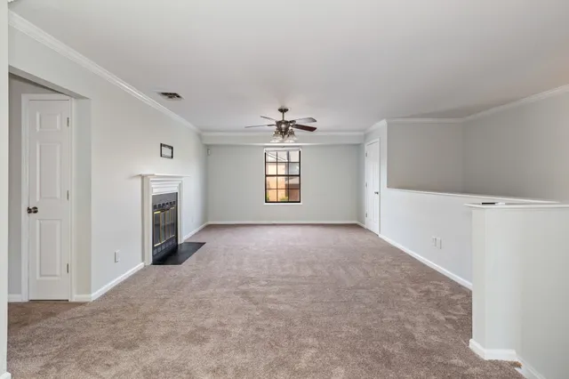 a view of a big room with windows and fireplace