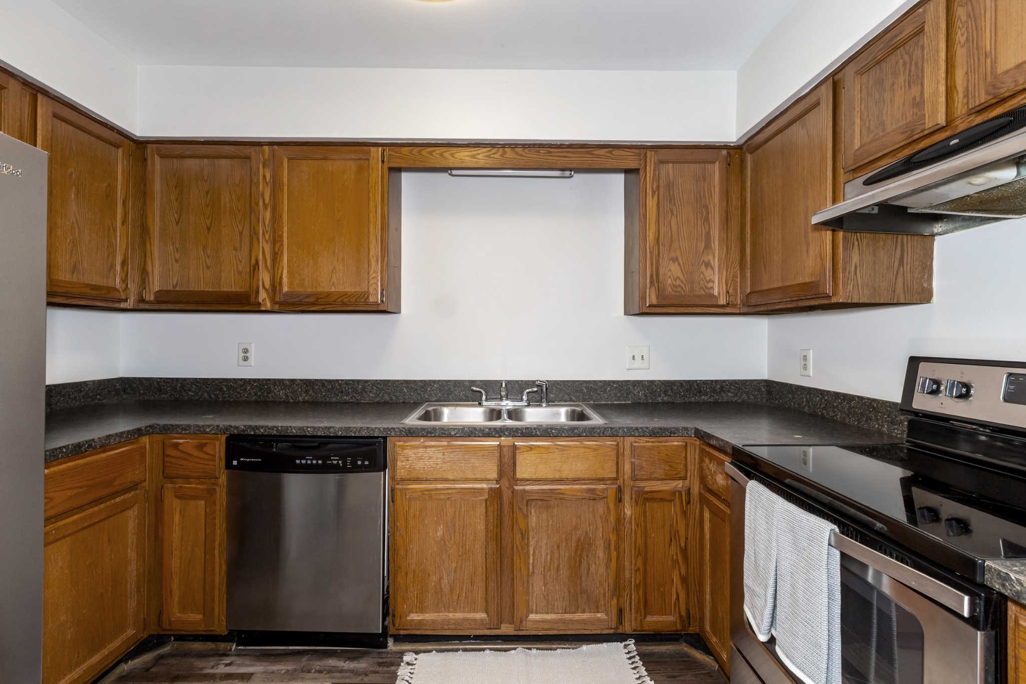 207 Ellington Place Madison, TN 37115 - Photo 18 of 24 a kitchen with granite countertop cabinets and black appliances