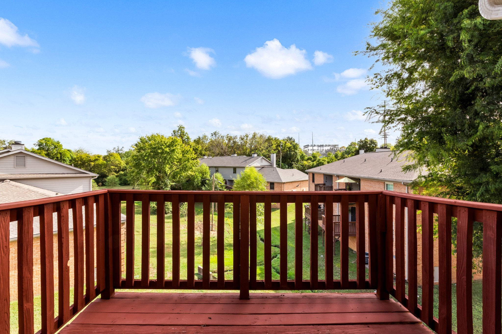 207 Ellington Place Madison, TN 37115 - Photo 5 of 24 a balcony with wooden floor and fence