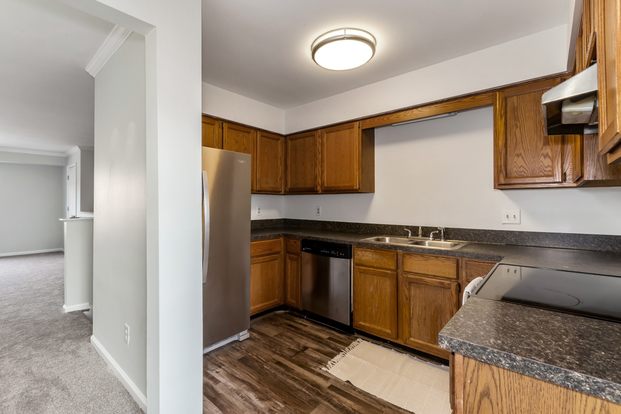 207 Ellington Place Madison, TN 37115 - Photo 7 of 24 a kitchen with granite countertop wood cabinets and stainless steel appliances