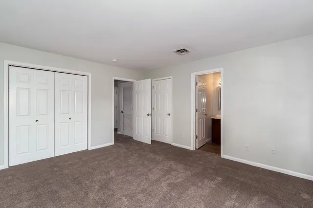 a view of an empty room and closet area