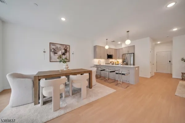 a living room with furniture and kitchen view